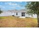 Spacious backyard with a sliding glass door and a fenced perimeter at 6816 Perch Hammock Loop, Groveland, FL 34736