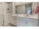 Bright and spacious bathroom featuring double sinks, white cabinetry, and a stand-up shower at 6816 Perch Hammock Loop, Groveland, FL 34736