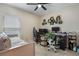 Bedroom featuring neutral walls, a window, desk, a bed, and an office setup at 6816 Perch Hammock Loop, Groveland, FL 34736