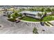 Aerial view of a clubhouse with a pool, parking lot, landscaping, and nearby homes at 6816 Perch Hammock Loop, Groveland, FL 34736