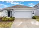 Charming single-story home with a well-manicured lawn and attached two-car garage at 6816 Perch Hammock Loop, Groveland, FL 34736