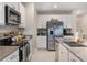 Bright kitchen with stainless steel appliances and plenty of counter space at 6816 Perch Hammock Loop, Groveland, FL 34736