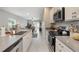 Modern kitchen featuring stainless steel appliances and bright gray countertops at 6816 Perch Hammock Loop, Groveland, FL 34736