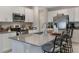 Modern kitchen featuring stainless steel appliances and bright gray countertops with bar stool seating at 6816 Perch Hammock Loop, Groveland, FL 34736