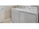 Bright laundry room featuring a washer and a dryer at 6816 Perch Hammock Loop, Groveland, FL 34736