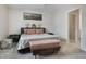 Bright primary bedroom featuring a king bed, neutral walls and an ensuite bathroom at 6816 Perch Hammock Loop, Groveland, FL 34736