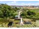 Aerial view of a community pond with a wooden deck, gazebo, lily pads, and surrounding trees at 6816 Perch Hammock Loop, Groveland, FL 34736