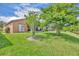 Spacious backyard with lush green lawn, and a screened in patio, perfect for outdoor living at 684 Grand Canal Dr, Kissimmee, FL 34759
