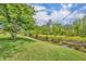 A lush green backyard with a peaceful water feature, offering a serene view at 684 Grand Canal Dr, Kissimmee, FL 34759