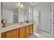 Well-lit bathroom includes a sink with wood cabinets, white tile floors, and a large mirror at 684 Grand Canal Dr, Kissimmee, FL 34759