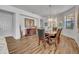 Formal dining room features wood floors, a decorative light fixture, and lovely wood furniture at 684 Grand Canal Dr, Kissimmee, FL 34759