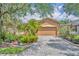 Charming single-story home with a well-manicured lawn and a paver driveway at 684 Grand Canal Dr, Kissimmee, FL 34759