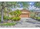 Charming single-story home with a well-manicured lawn and a paver driveway at 684 Grand Canal Dr, Kissimmee, FL 34759