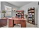 Well-lit home office featuring a large wooden desk, ample storage, and a cozy, professional atmosphere at 684 Grand Canal Dr, Kissimmee, FL 34759