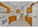 Functional kitchen with tile flooring, oak cabinets, white appliances, and plenty of storage at 684 Grand Canal Dr, Kissimmee, FL 34759