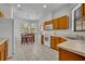 Eat-in kitchen features white appliances, oak cabinets, tile flooring, and multiple windows for natural light at 684 Grand Canal Dr, Kissimmee, FL 34759