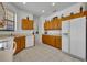 Bright kitchen offers oak cabinets, white appliances, tile floors, and ample counter space, perfect for cooking at 684 Grand Canal Dr, Kissimmee, FL 34759