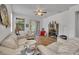 View of a living room with white sofas, a ceiling fan and beautiful decor at 684 Grand Canal Dr, Kissimmee, FL 34759
