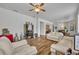 View of a living room with white sofas, a ceiling fan and beautiful decor at 684 Grand Canal Dr, Kissimmee, FL 34759