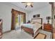 Serene main bedroom features soft carpet, a ceiling fan, and a door leading to a private outdoor space at 684 Grand Canal Dr, Kissimmee, FL 34759