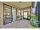Enclosed patio with brick flooring, plants, and sliding glass doors leading to interior at 684 Grand Canal Dr, Kissimmee, FL 34759