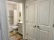 This bathroom connects to the bedroom; it includes a tub with shower, a toilet, and a sink and vanity at 7394 Lussier Ct, The Villages, FL 34762