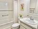 Clean bathroom featuring a tub with shower, vanity with sink, and a light, airy feel at 7394 Lussier Ct, The Villages, FL 34762