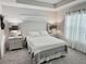 Bright, well-lit bedroom with neutral tones, decorative lamps and sheer curtains at 7394 Lussier Ct, The Villages, FL 34762