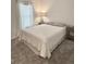 Comfortable bedroom with soft carpet, large window, and soothing neutral tones for relaxation at 7394 Lussier Ct, The Villages, FL 34762