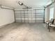 Spacious two-car garage featuring a clean concrete floor, and plenty of room for parking and storage at 7394 Lussier Ct, The Villages, FL 34762