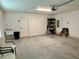 Clean garage with a utility sink, storage rack and ladder at 7394 Lussier Ct, The Villages, FL 34762