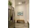 Hallway with stainless steel refrigerator, woven bench, and boat picture, offering a blend of functionality and style at 7394 Lussier Ct, The Villages, FL 34762