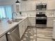 Modern kitchen with stainless steel appliances, decorative rug, light countertops, and stylish breakfast bar at 7394 Lussier Ct, The Villages, FL 34762
