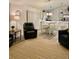 An open-concept living area showcasing a kitchen with white cabinetry and stainless steel appliances at 7394 Lussier Ct, The Villages, FL 34762
