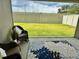 Covered patio area with outdoor seating and a view of the backyard at 7394 Lussier Ct, The Villages, FL 34762