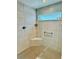 Modern bathroom shower with stylish tile, corner seat, and glass door, offering a spa-like experience at 7394 Lussier Ct, The Villages, FL 34762