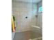 Modern bathroom shower featuring updated tile, a comfortable corner seat, and a sleek design at 7394 Lussier Ct, The Villages, FL 34762