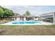 Full backyard with a pool, covered patio and seating at 800 Jefferis Ct, Eustis, FL 32726