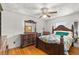Bedroom featuring decorative bed frame, dresser, bedside table and hardwood flooring at 800 Jefferis Ct, Eustis, FL 32726