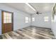 This bonus room features updated flooring, three windows, and a ceiling fan at 800 Jefferis Ct, Eustis, FL 32726