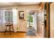 Warm entryway with hardwood floors, decorative mirror, and charming details at 800 Jefferis Ct, Eustis, FL 32726