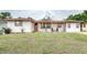 Charming single-story home with a cozy covered porch and well-maintained front lawn at 800 Jefferis Ct, Eustis, FL 32726