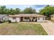Single-story home featuring a covered porch and well-maintained lawn at 800 Jefferis Ct, Eustis, FL 32726