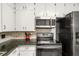 Beautiful kitchen featuring black appliances and sleek granite countertops at 800 Jefferis Ct, Eustis, FL 32726