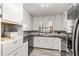 Charming kitchen with white cabinets and sleek granite countertops at 800 Jefferis Ct, Eustis, FL 32726