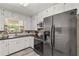 Well-lit kitchen with modern stainless steel appliances and white cabinetry at 800 Jefferis Ct, Eustis, FL 32726