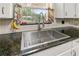 Close-up of a stainless steel kitchen sink with a granite countertop at 800 Jefferis Ct, Eustis, FL 32726