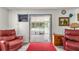Inviting living room with bright doorway view of enclosed pool and patio at 800 Jefferis Ct, Eustis, FL 32726