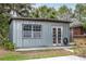 This outbuilding has double doors, a window, concrete foundation, and metal siding at 800 Jefferis Ct, Eustis, FL 32726