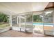 View of the pool from the screened in porch with wood-look flooring at 800 Jefferis Ct, Eustis, FL 32726